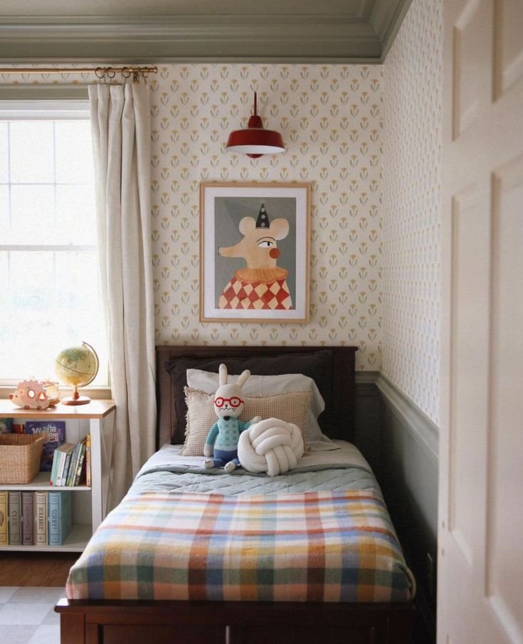 Chambre enfant style vintage avec papier peint à imprimés et lampe rouge