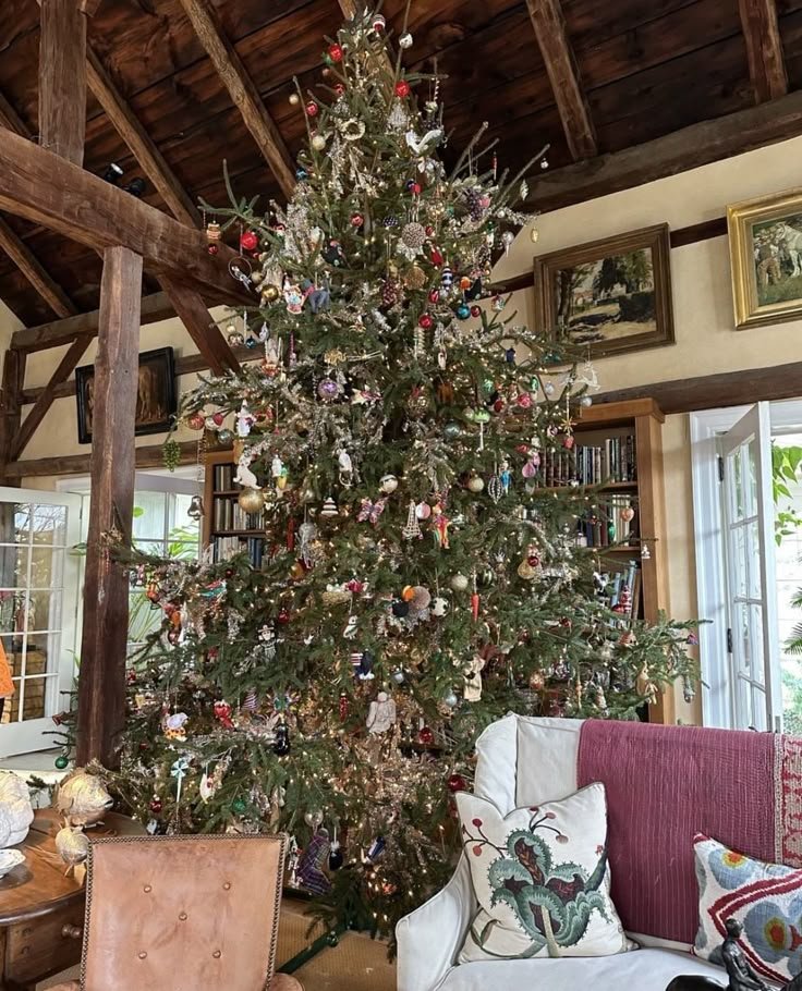 Grand sapin de noël dans chalet avec canapé blanc