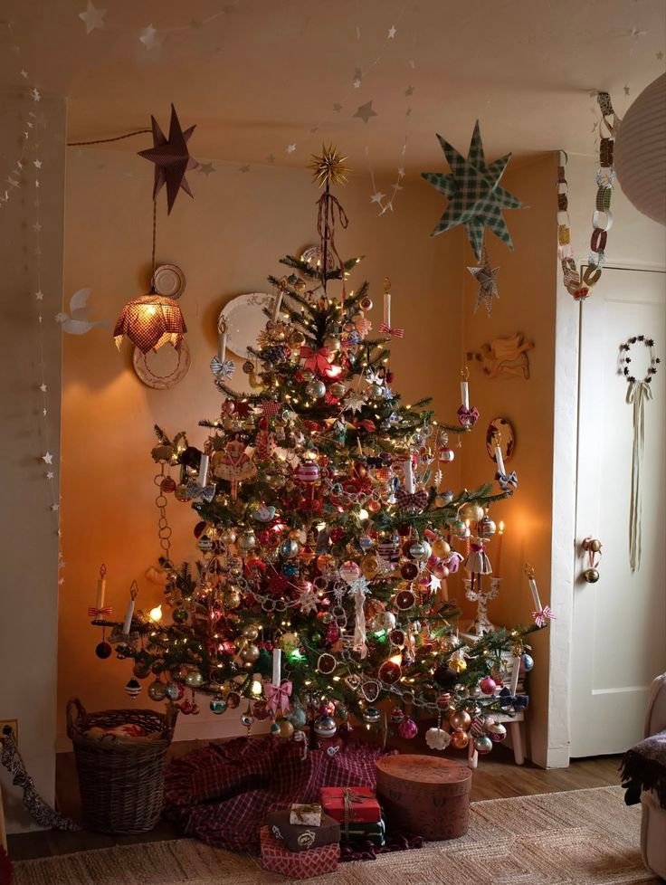 Inspiration-sapin-de-noel-maximaliste-avec-oranges-sechees-bougies-et-guirlandes-dans-piece-scandinave